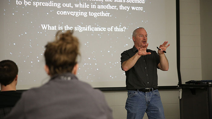 Dr. Michael Reed gives a lecture in an astronomy class.